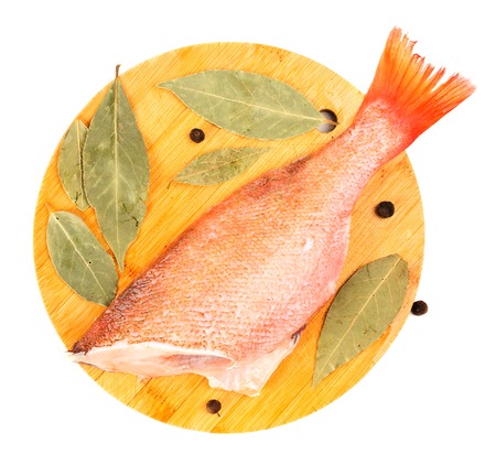 The split sea bass on a round cutting board 