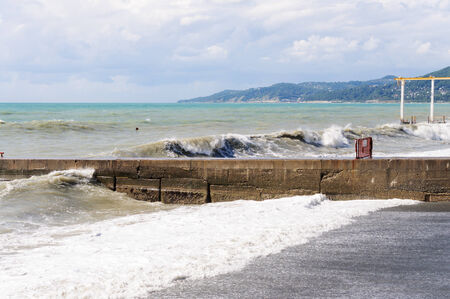 Storm waves roll on the concrete breakwaterの写真素材