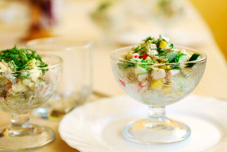 Meat salad in a glass vase.