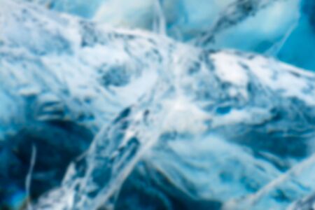 Abstract Blue river ice with large cracks. Deep blur.の写真素材