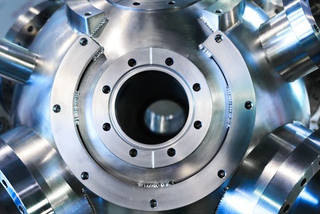 Industrial background, heavy metal housing with welded metal flanges.