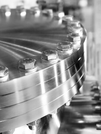Flanged vacuum equipment. Shiny metal surface. A metal surface treated.