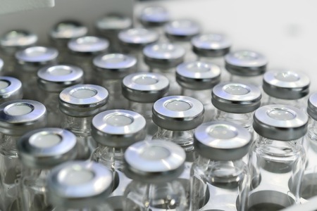 Glass vials for liquid samples. Laboratory equipment for dispensing fluid samples. Shallow depth of field.の写真素材
