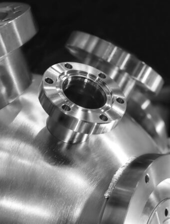 Flanged vacuum equipment. Shiny metal surface. Focus on a casing.