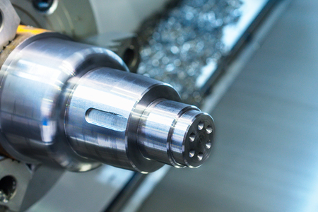 A metal workpiece clamped in the lathe chuck CNC machine. Shallow depth of field.の写真素材