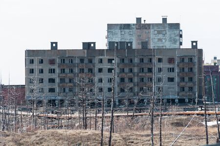 Derelict high-rise building in Norilsk. House on pile foundation, built on permafrost.の写真素材