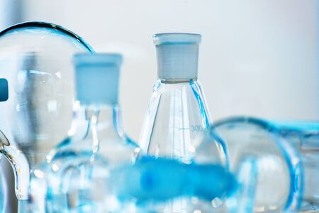 Chemical laboratory glassware. Blue abstract background. Shallow depth of field.の写真素材