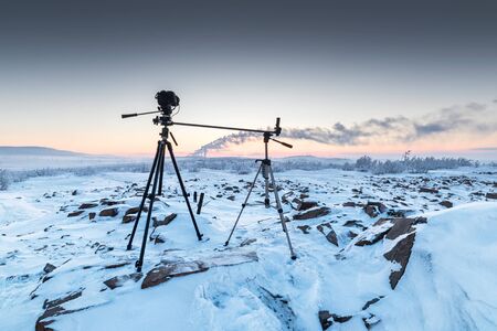 The camera on the two tripods during timelapse shooting. Arctic tundra, winter.