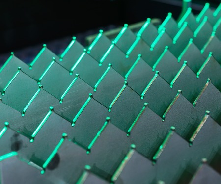 Desktop CNC sheet metal laser cutting machine. Abstract industrial background. Shallow depth of...