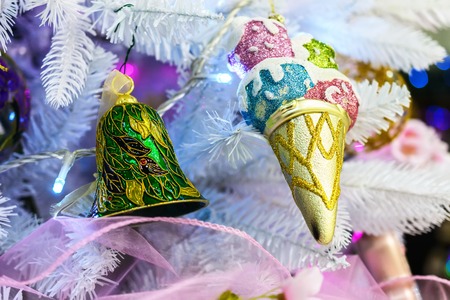 Christmas decorations on artificial fir. Christmas teddy glass ball with patterns.の写真素材