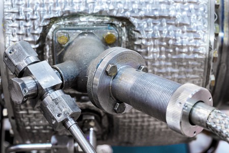 Details of old aircraft engine. Nuts connecting tubes, nozzles, combustion chamber insulation.