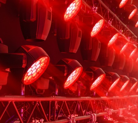 Stage lighting equipment. Modern Concert spotlight. The direct rays of light in the haze.