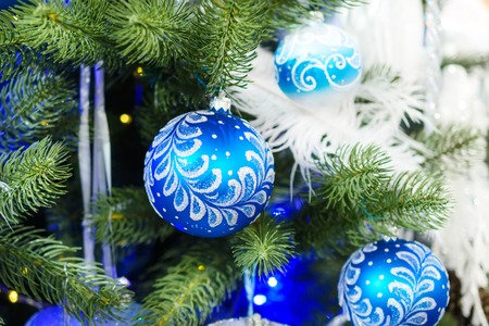 Christmas decorations on artificial Christmas tree. Blue Christmas toy balls with patterns.の写真素材