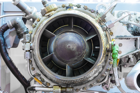 The gas-turbine auxiliary power unit. View from the air turbine. Nuts connecting tubes, nozzles,...