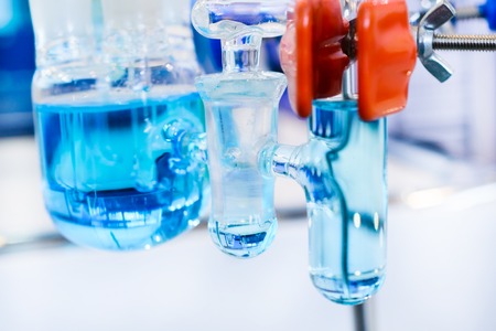 Glass chemical equipment, pipes and shut-off valves. Chemical glass. Shallow depth of field.