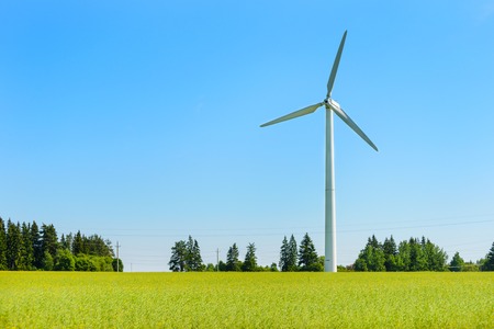 Wind generator in the meadows, on a background of blue sky. An alternative source of electricity....