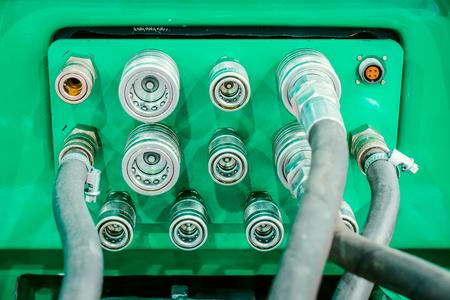 Several hydraulic coupling connector on a green panel.の写真素材