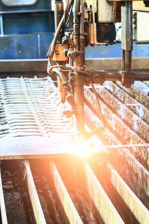 Oxygen torch cuts steel sheet. CNC gas cutting machine. Bright sheaf of sparks of molten metalの写真素材