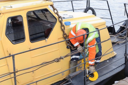 MOSCOW, RUSSIA - NOVEMBER 11, 2016: State Unitary Enterprise Mosvodostok performs recovery vessels on coastal winter parking. Work secures the chain sling on the lug.のeditorial素材