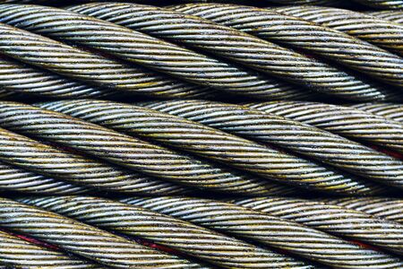 Industrial abstract background. Steel cable close-up photo. New rope lubrication.の写真素材