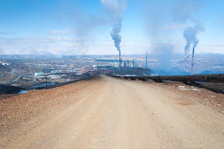 Mountain gravel road. The wide road leads to the smelter. Industrial peyzhaz.の写真素材