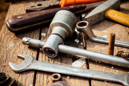 On weathered old wooden surface lie the , oily wrenches.の写真素材