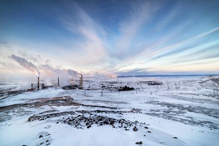 Winter landscape with the smoking pipes of steel works.の写真素材