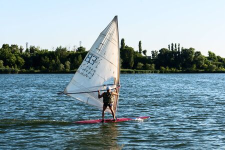 KURCHATOW, RUSSIA - JUNE 23, 2016: Windsurfers are trained on a large lake. Evening shot.のeditorial素材