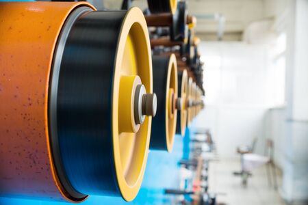 Rotating rubberized wheels of the winding machine.の写真素材