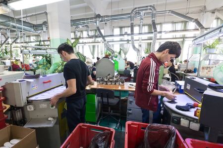 MOSCOW, RUSSIA - FEBRUARY 21, 2017: Moscow shoe factory JSC RALF RINGER . Female and male workers on a sewing machine.のeditorial素材