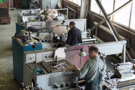 team of turners works behind lathes.のeditorial素材