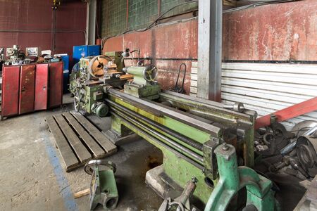 Old vintage lathe in the factory shop.