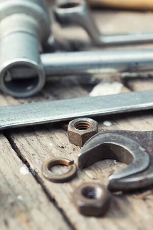 On weathered old wooden surface lie the , oily wrenches.の写真素材