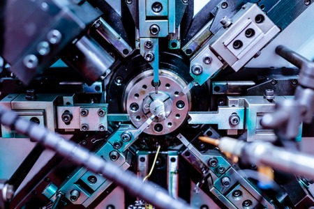 Automatic CNC bending machine. Manufacture of a spring of fine wireの写真素材