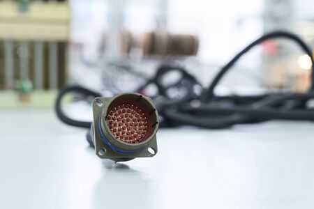 Circular multi-pin connector lie on the table.