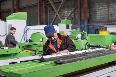 Work on the preparation of the bed of a metal-cutting machine for assembly. The locksmith performs a...