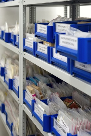 Blue plastic boxes placed in shelves.の写真素材