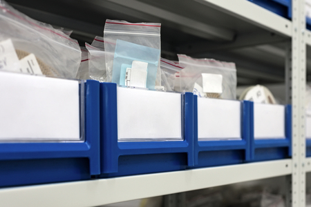 Blue plastic trays in metal racks.の写真素材