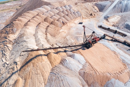 An industrial spreader in the process of work. The process of pouring rock pilesの写真素材
