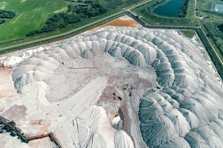 Warehouse of unused rock. Ore is stored in huge mounds. A system of long belt conveyors and spreaders.の写真素材