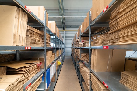 Warehouse shelves with cardboard boxes and packs in paper packagingの写真素材