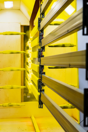 Powder coating line. Camera painting products in an electrostatic fieldの写真素材