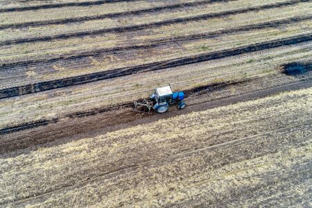 A tractor plows a field. Agricultural work.の写真素材