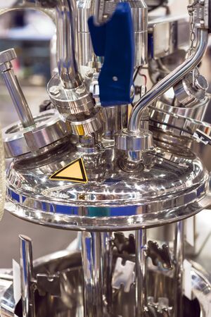 Chemical reactor. Clean pharmaceutical equipment, lots of sparkling chrome plumbing. Modern...