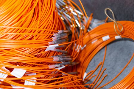Coils with detonation cord. Multi-colored wire of orange and yellow.