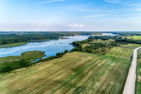 Beautiful aerial shot of a large forest lake. Summer landscape with the setting sun. Typical view...