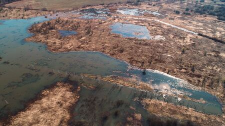 Early spring, flood. Water spilled over the fields. Aerial view.