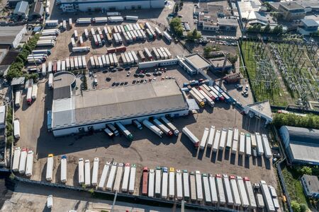 Lots of freight trailers. Cars are in several rows.