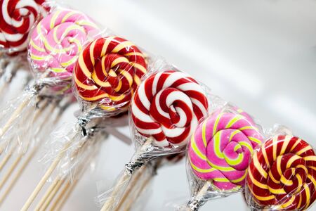 Christmas candy canes Sweet lollipops, sweets are arranged in an even row.