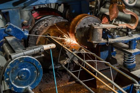 Machine for the manufacture of reinforced concrete carcass piles. Automatic spot welding of metal...